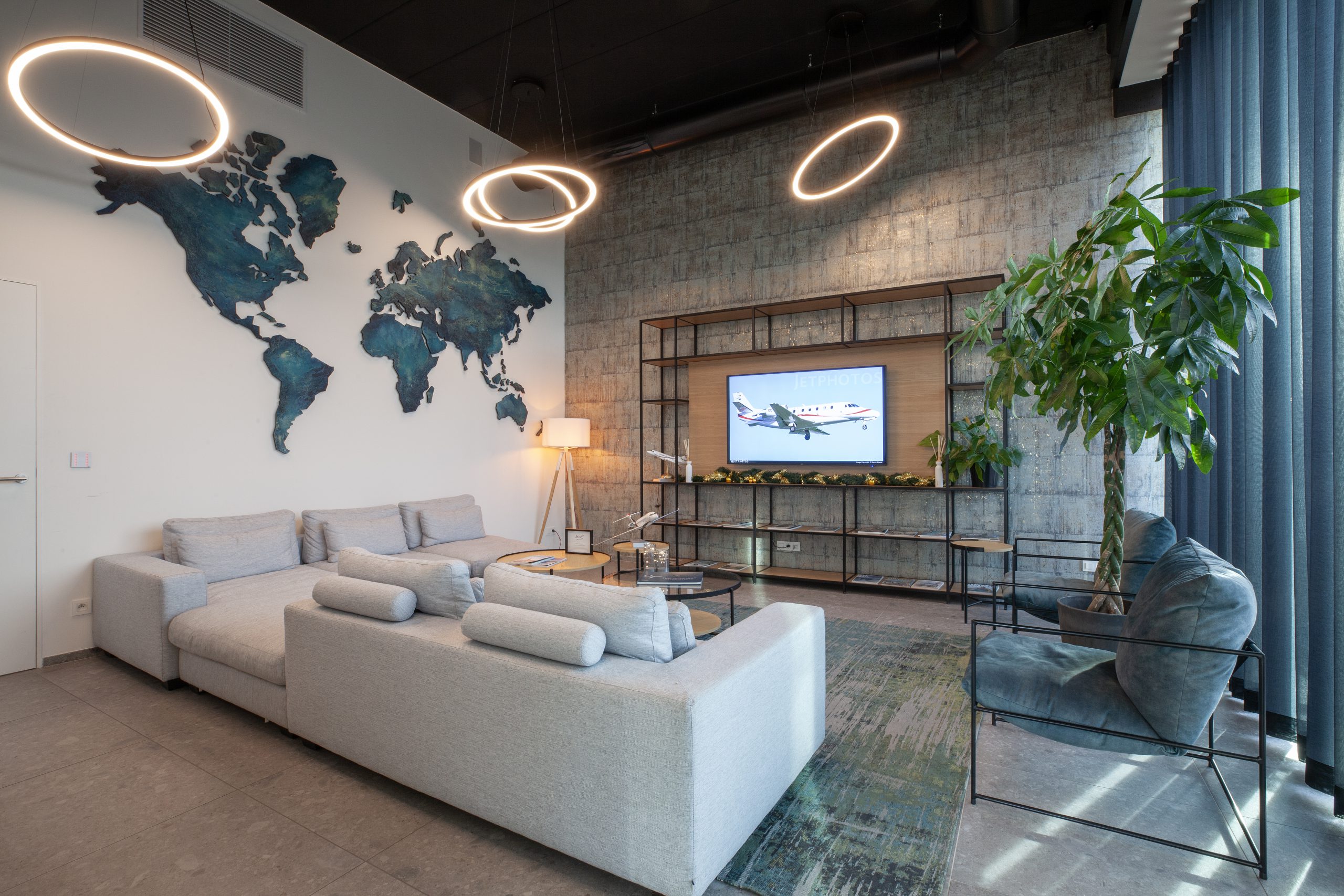 Lounge seating area with a wall-mounted TV screen at ASL Group's terminal